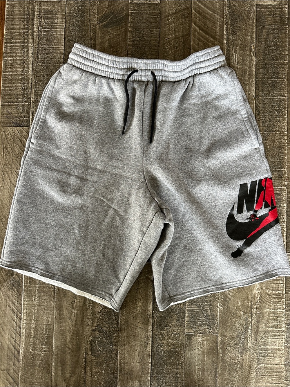 Nike Men's Grey Athletic Logo Shorts with Red Accent